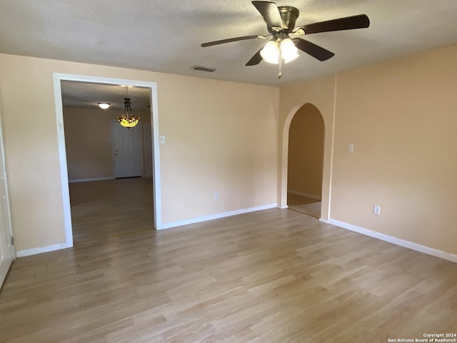 305 Osage, Refugio, TX 78377 - spare room with arched walkways, light wood finished floors, and ceiling fan