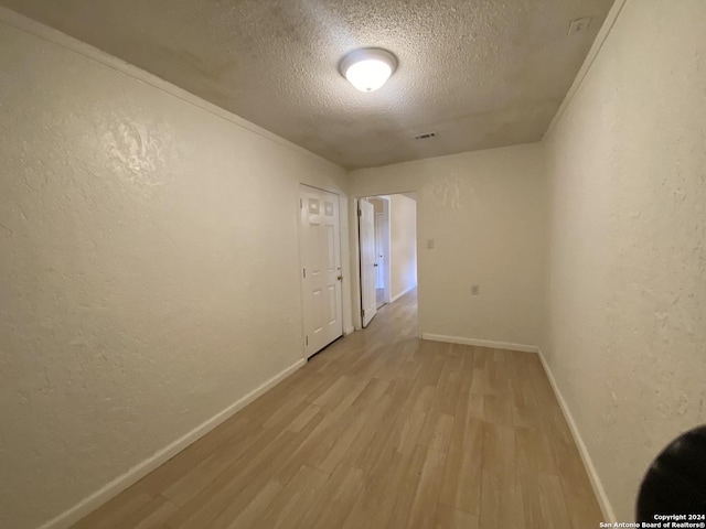 305 Osage, Refugio, TX 78377 - unfurnished room with a textured ceiling, wood finished floors, and a textured wall