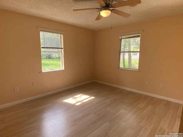 305 Osage, Refugio, TX 78377 - empty room with light wood finished floors, a textured ceiling, and ceiling fan