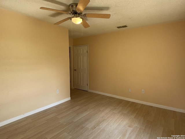 305 Osage, Refugio, TX 78377 - empty room with light wood-type flooring, ceiling fan, and a textured ceiling