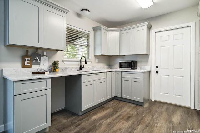211 Balboa, Universal City, TX 78148 - kitchen with gray cabinets, dark wood-style floors, and light stone countertops