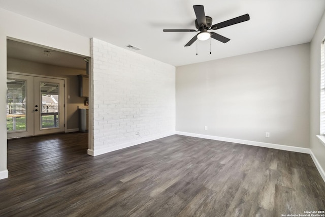 211 Balboa, Universal City, TX 78148 - unfurnished room with a ceiling fan, dark wood-type flooring, french doors, and brick wall