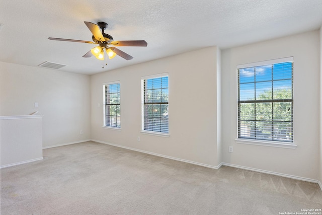 5614 Cross Pond, San Antonio, TX 78249 - spare room with plenty of natural light, light colored carpet, a ceiling fan, and a textured ceiling