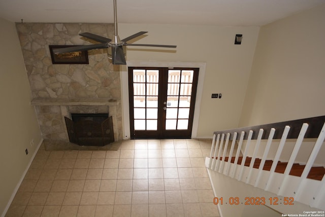 4107 Medical Dr Unit 8204, San Antonio, TX 78229 - unfurnished living room with tile patterned floors, french doors, a ceiling fan, and a fireplace