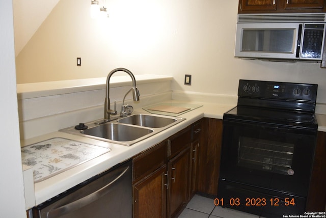 4107 Medical Dr Unit 8204, San Antonio, TX 78229 - kitchen featuring stainless steel appliances, light countertops, dark brown cabinetry, and light tile patterned flooring