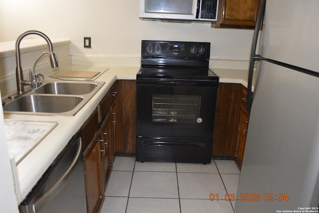4107 Medical Dr Unit 8204, San Antonio, TX 78229 - kitchen featuring appliances with stainless steel finishes, light countertops, light tile patterned floors, and dark brown cabinets