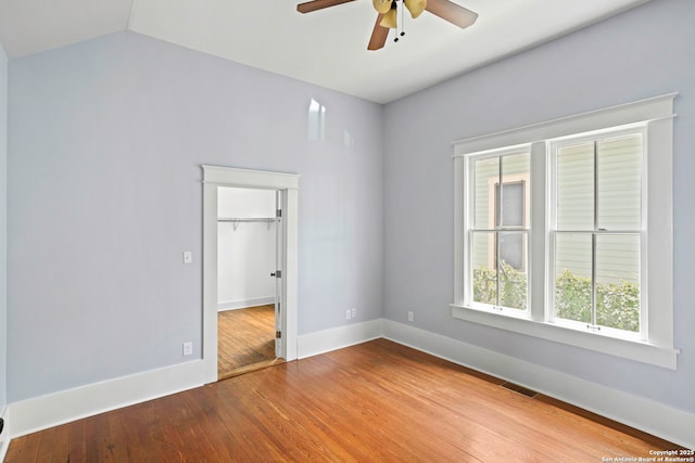 110 Vitra, San Antonio, TX 78210 - unfurnished room with a ceiling fan, wood finished floors, and vaulted ceiling