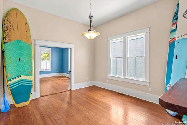 110 Vitra, San Antonio, TX 78210 - unfurnished dining area featuring wood-type flooring and baseboards