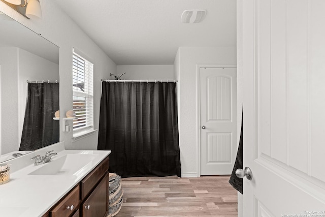 6583 Runaway, Converse, TX 78109 - full bath with wood finished floors, vanity, and a shower with curtain