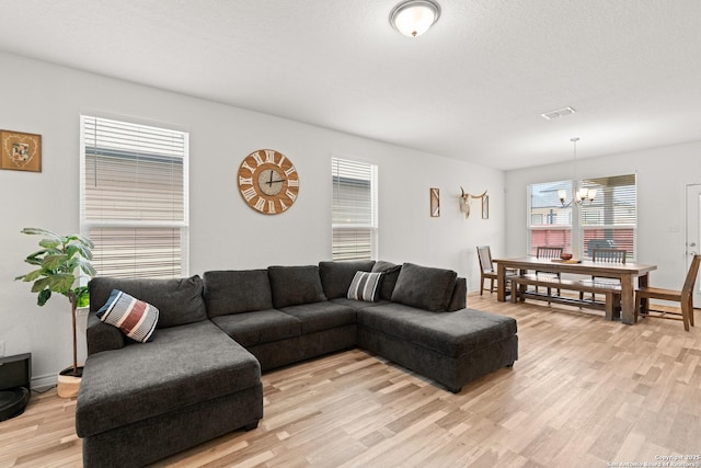 6583 Runaway, Converse, TX 78109 - living room featuring a chandelier and light wood-style flooring