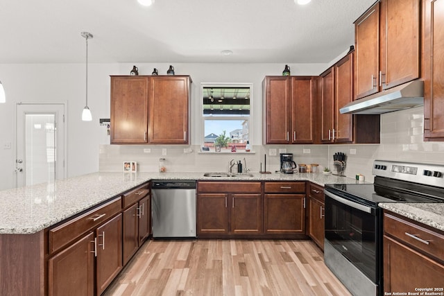 6583 Runaway, Converse, TX 78109 - kitchen featuring stainless steel appliances, under cabinet range hood, a peninsula, and light wood-style floors