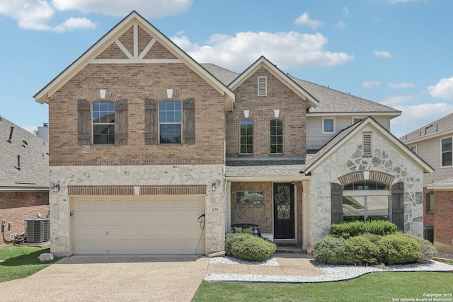 630 Oxalis, San Antonio, TX 78260 - view of front of home with stone siding, concrete driveway, brick siding, a garage, and a shingled roof