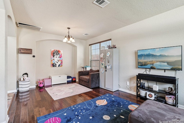 630 Oxalis, San Antonio, TX 78260 - living room featuring a chandelier, wood finished floors, and a textured ceiling