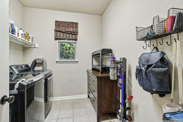 630 Oxalis, San Antonio, TX 78260 - laundry room featuring washing machine and clothes dryer and light tile patterned flooring