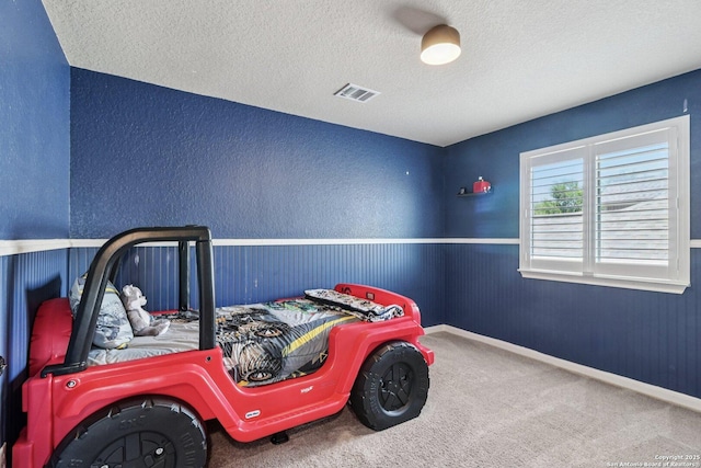630 Oxalis, San Antonio, TX 78260 - bedroom with a textured ceiling, carpet, wainscoting, and a textured wall