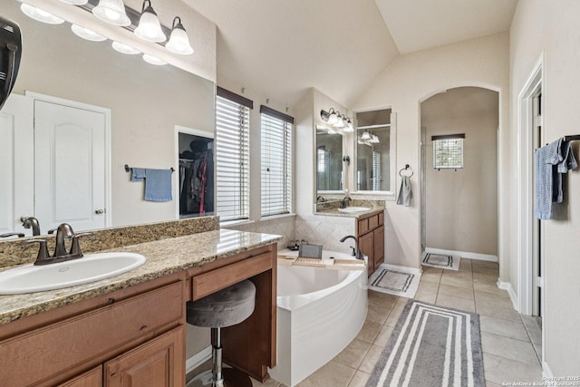 630 Oxalis, San Antonio, TX 78260 - full bathroom with a stall shower, a garden tub, vanity, vaulted ceiling, and tile patterned floors