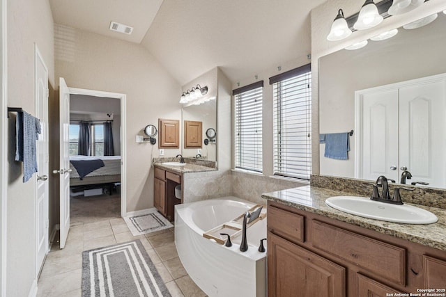630 Oxalis, San Antonio, TX 78260 - ensuite bathroom featuring lofted ceiling, plenty of natural light, a bath, two vanities, and tile patterned flooring