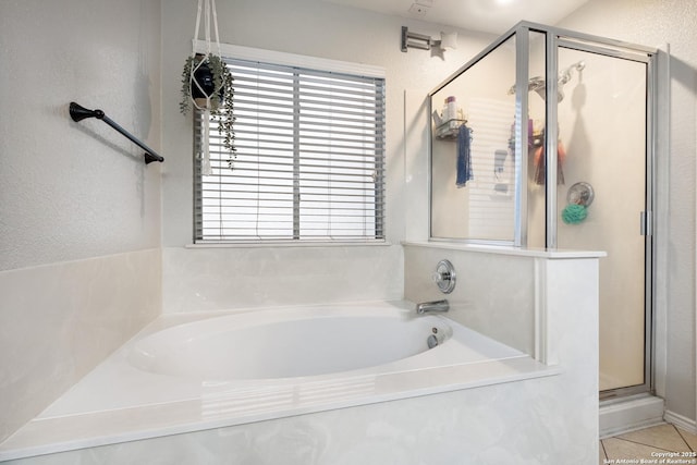7907 Oakwood Pnes, San Antonio, TX 78254 - full bathroom featuring a shower stall, a garden tub, healthy amount of natural light, and a textured wall