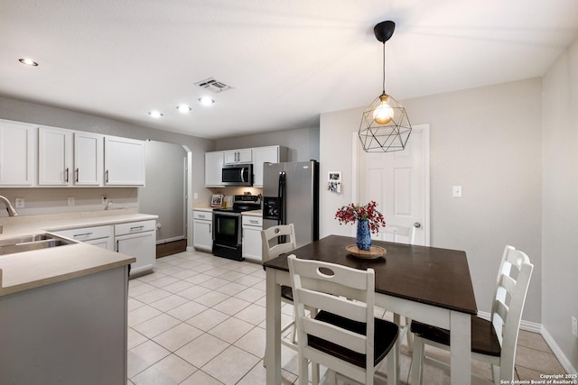 7907 Oakwood Pnes, San Antonio, TX 78254 - kitchen with appliances with stainless steel finishes, light tile patterned floors, light countertops, and arched walkways