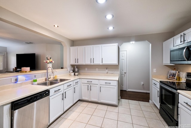 7907 Oakwood Pnes, San Antonio, TX 78254 - kitchen with stainless steel appliances, white cabinetry, light countertops, light tile patterned floors, and recessed lighting