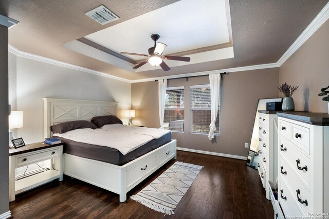 7907 Oakwood Pnes, San Antonio, TX 78254 - bedroom featuring a tray ceiling, dark wood finished floors, ornamental molding, ceiling fan, and a textured ceiling