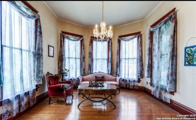 9248 Fm 725, Mcqueeney, TX 78123 - sitting room featuring a chandelier, crown molding, and wood finished floors