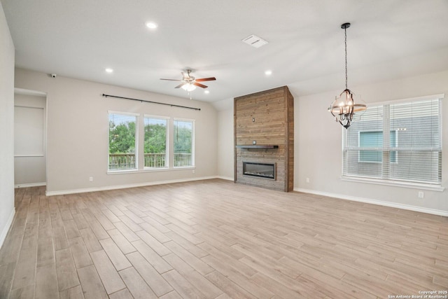 1533 Cawdon Park, Bulverde, TX 78163 - unfurnished living room with light wood finished floors, a large fireplace, a ceiling fan, recessed lighting, and a chandelier