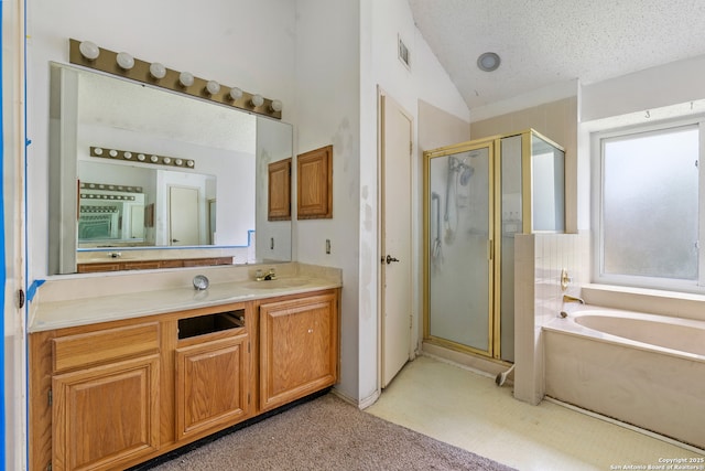 11305 Forest Night, Live Oak, TX 78233 - full bathroom featuring a shower stall, a garden tub, vanity, vaulted ceiling, and a textured ceiling