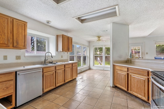 11305 Forest Night, Live Oak, TX 78233 - kitchen featuring stainless steel appliances, healthy amount of natural light, a textured ceiling, and light countertops
