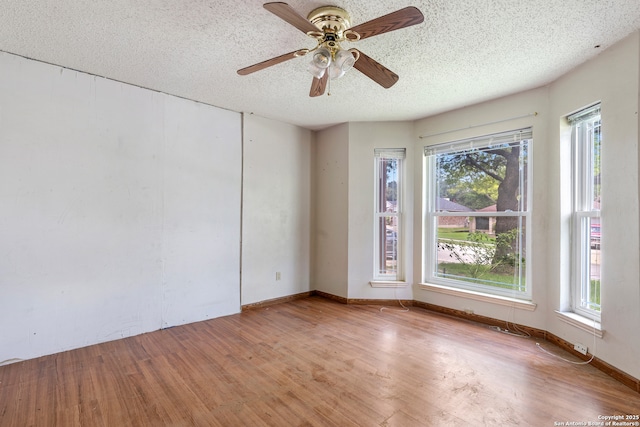11305 Forest Night, Live Oak, TX 78233 - spare room with a textured ceiling, wood finished floors, plenty of natural light, and a ceiling fan