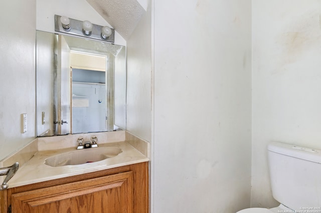 11305 Forest Night, Live Oak, TX 78233 - bathroom featuring vanity, a textured ceiling, and lofted ceiling