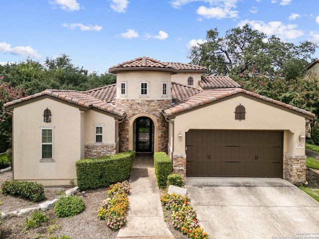 22715 Colibries, San Antonio, TX 78261 - mediterranean / spanish house featuring stone siding, stucco siding, an attached garage, concrete driveway, and a tiled roof