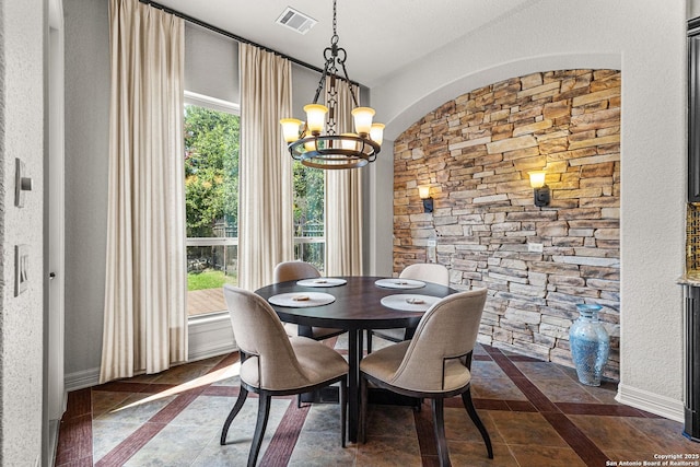 22715 Colibries, San Antonio, TX 78261 - dining room featuring a chandelier, inlaid floor details, and arched walkways