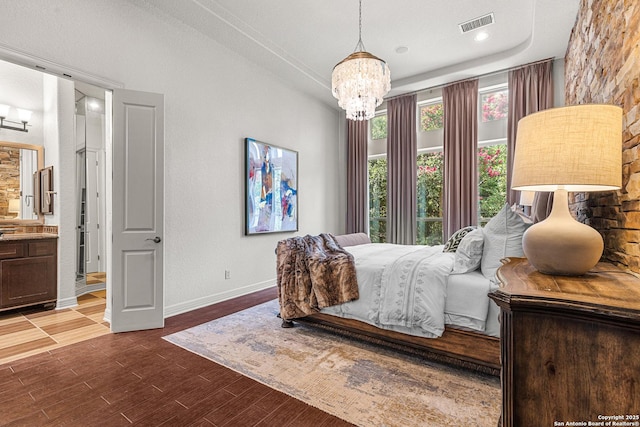 22715 Colibries, San Antonio, TX 78261 - bedroom with a chandelier, dark wood-type flooring, ensuite bathroom, and a raised ceiling