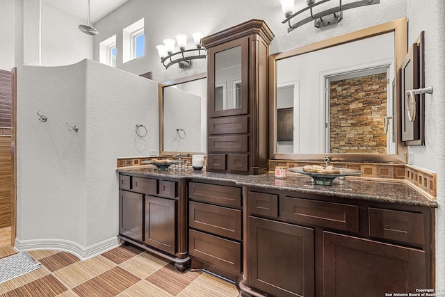 22715 Colibries, San Antonio, TX 78261 - full bathroom featuring a textured wall, double vanity, a shower, and tile patterned floors