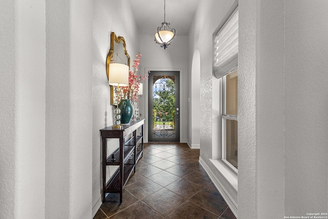 22715 Colibries, San Antonio, TX 78261 - entryway featuring dark tile patterned floors, arched walkways, and a textured wall