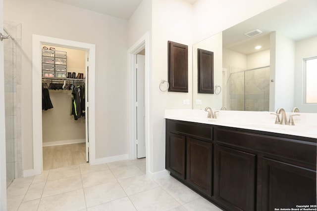 14946 Costa Leon, San Antonio, TX 78245 - full bath featuring a shower stall, a spacious closet, double vanity, and tile patterned floors