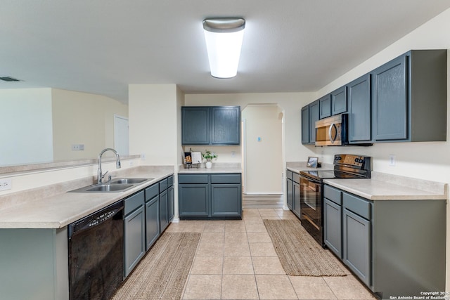 109 Bay Willow, Cibolo, TX 78108 - kitchen featuring black appliances, a peninsula, light countertops, and light tile patterned floors