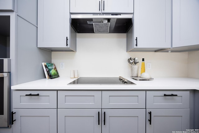 326 Cactus, San Antonio, TX 78203 - kitchen with range hood, black electric cooktop, light countertops, and gray cabinets