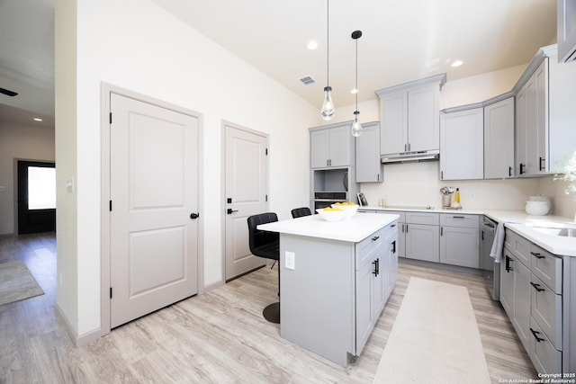326 Cactus, San Antonio, TX 78203 - kitchen featuring gray cabinetry, a center island, light wood-style flooring, light countertops, and recessed lighting