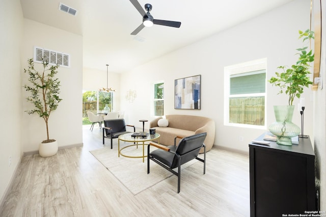326 Cactus, San Antonio, TX 78203 - living room with light wood finished floors, a ceiling fan, and a chandelier