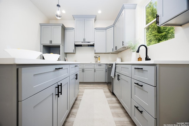 326 Cactus, San Antonio, TX 78203 - kitchen featuring gray cabinetry, light wood-style flooring, under cabinet range hood, recessed lighting, and decorative light fixtures