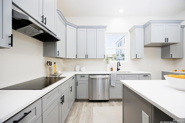 326 Cactus, San Antonio, TX 78203 - kitchen featuring dishwasher, black electric cooktop, under cabinet range hood, light wood-type flooring, and recessed lighting