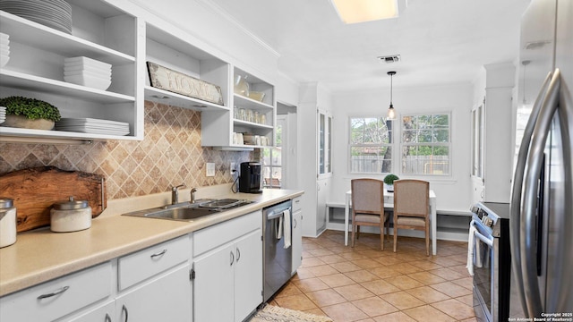 1703 Redwood, Seguin, TX 78155 - kitchen with appliances with stainless steel finishes, open shelves, tasteful backsplash, light countertops, and white cabinetry