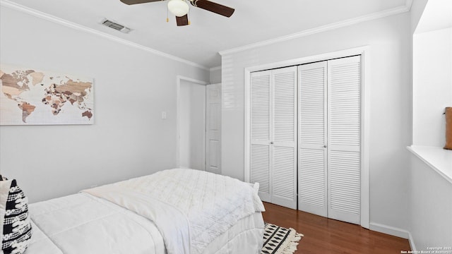 1703 Redwood, Seguin, TX 78155 - bedroom with dark wood-style flooring, ornamental molding, a closet, and a ceiling fan