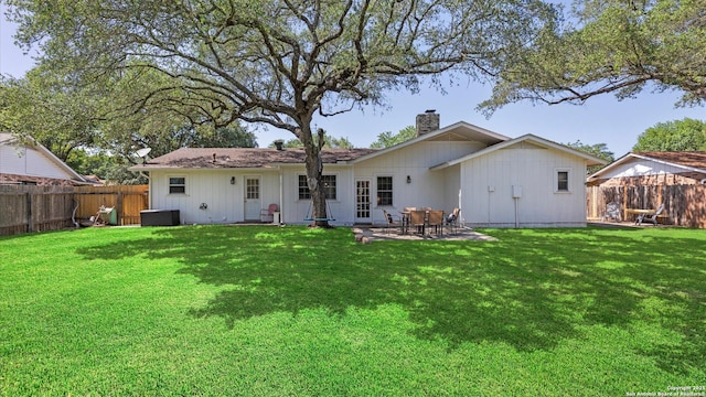 1703 Redwood, Seguin, TX 78155 - back of property featuring a chimney, a fenced backyard, and a patio area