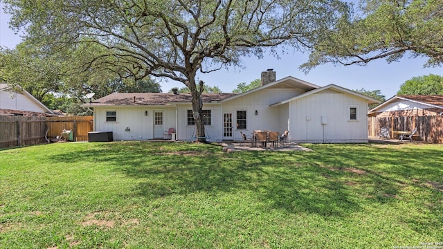 1703 Redwood, Seguin, TX 78155 - back of property with a chimney, a fenced backyard, and a patio