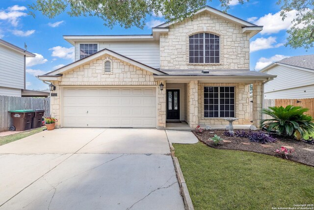 9915 Mustang Isle, San Antonio, TX 78254 - view of front of house with stone siding, concrete driveway, and an attached garage
