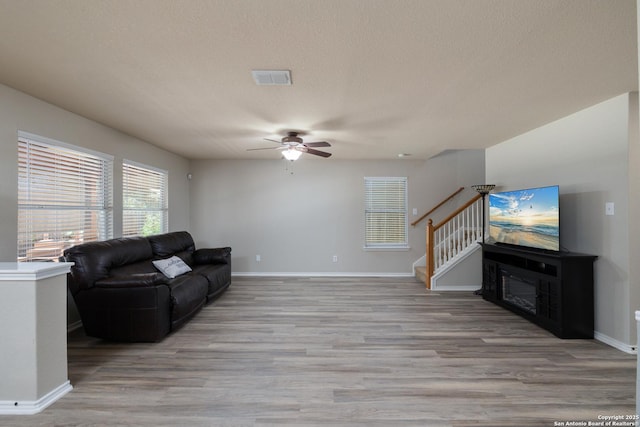 9915 Mustang Isle, San Antonio, TX 78254 - living area with ceiling fan, light wood finished floors, and stairs