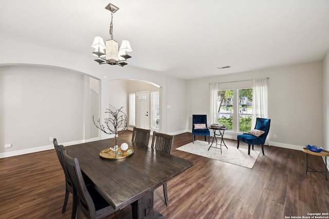 18310 Redwood Path, San Antonio, TX 78259 - dining room with arched walkways, a chandelier, and wood finished floors